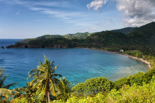Tropical paradise: hidden beach along the turquoise seashore wit
