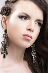 Fototapeta premium Young woman beauty portrait with earrings