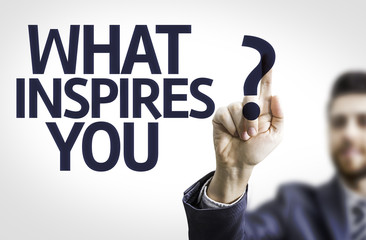 Business man pointing the text: What Inspires You?