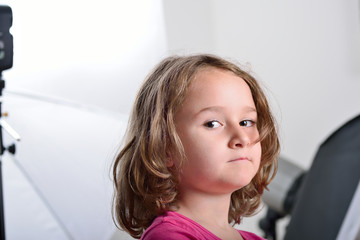 Little girl visiting and having fun in a photo studio