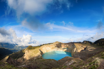 Steaming voulcanic colorful lakes in Kelimutu kraters on a brigh
