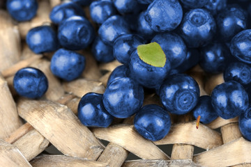 Fresh blueberries on wicker mat close-up