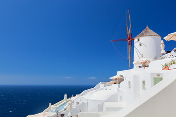 Oia town on Santorini island, Greece.  Famous windmills