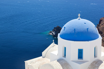 Fototapeta na wymiar Oia, Santorini island, Greece. White church with blue dome