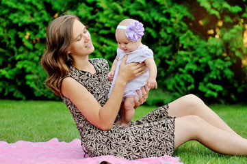 Obraz premium Beautiful Mother And Baby playing in a park. outdoors. Nature. B