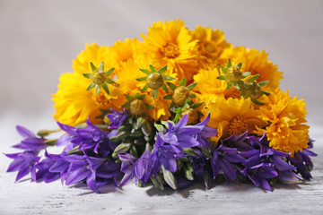 Beautiful wild flowers on wooden background