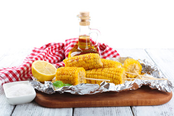 Grilled corn cobs on table, close-up