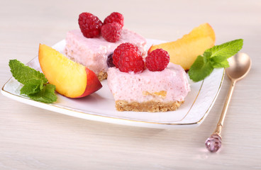 Cake with fruits and berries on plate on wooden background