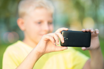 boy photographed on a smartphone
