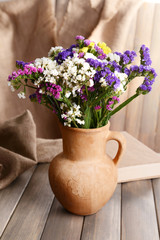 Obraz na płótnie Canvas Beautiful bouquet of bright flowers in pitcher