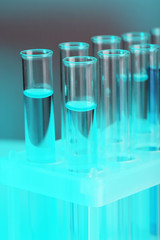 Test tubes with liquid on grey background