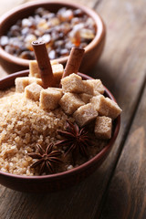 Brown sugar cubes and crystal sugar with spices in bowl