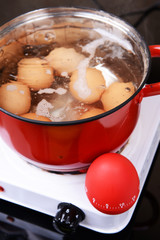 Eggs in boiling water in pan on electric hob