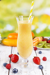 Delicious berry cocktail on table on bright background