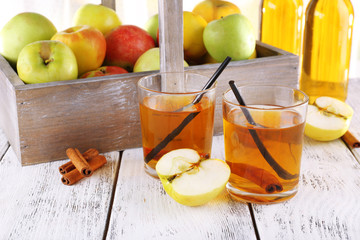 still life with apple cider and fresh apples on wooden table