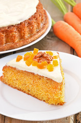 Piece of carrot cake with icing decorated dried apricots and wal