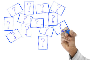 Many Question Marks are drawn on transparent wipe board