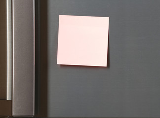 Note on piece of paper on refrigerator closeup © Africa Studio
