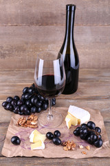 beautiful still life with wine, cheese and ripe grape