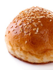 Tasty bun with sesame isolated on white