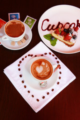 Cup of coffee with cute drawing in cafe