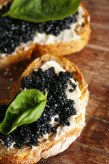 Slices of bread with butter and black caviar