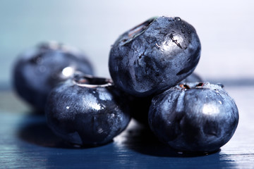 Tasty ripe blueberries, on wooden background