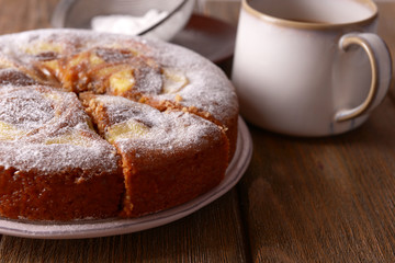 Delicious cake and cup of coffee on wooden table