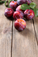 Sweet plums on wooden background