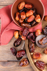 Tasty dates fruits on wooden background