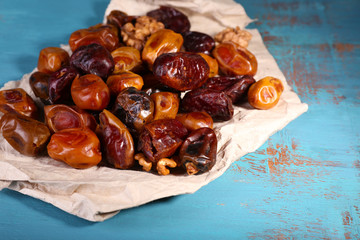 Tasty dates fruits on blue wooden table