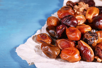 Tasty dates fruits on blue wooden table