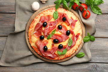 Delicious pizza served on wooden table