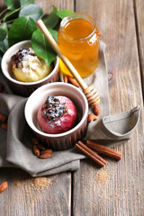 Baked apples in bowls on table close up