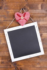 Square chalkboard on wooden background