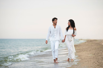 Romantic couple walking along the seaside