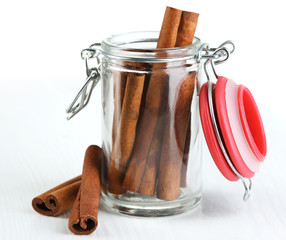 Cinnamon bark in glass bank on wooden table