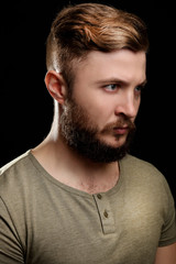 Fototapeta premium Portrait of handsome man with beard on black background