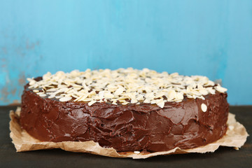 Tasty chocolate cake with almond, on old wooden table