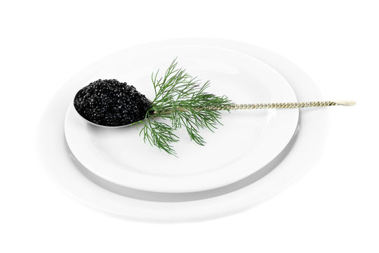 Spoon with black caviar on plate isolated on white