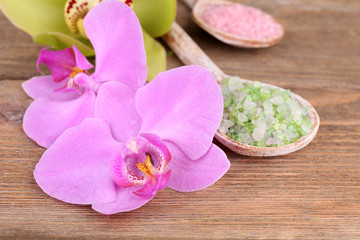 Naklejka na ściany i meble Tropical orchid flowers and sea salt in wooden spoons