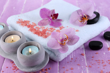 Orchid flowers, spa stones, candles and towel