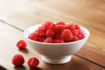 Fresh raspberries in white bowl