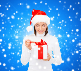 smiling woman in santa helper hat with gift box