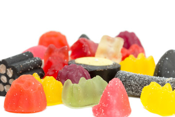 Closeup of several mixed sugary candies isolated on white