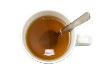 Closeup of a cup of tea with spoon viewed from above, isolated