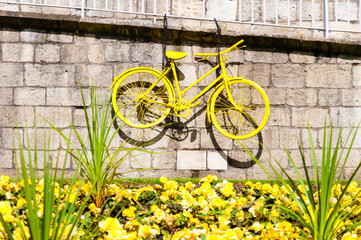 Yellow bicycle exposed on York city walls, England