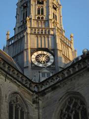 part of a church tower with the clock in the middle