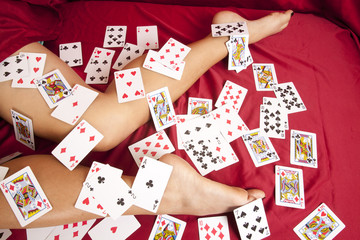 woman legs lay red sheet cards all over