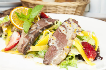 salad of duck meat and vegetables in a restaurant